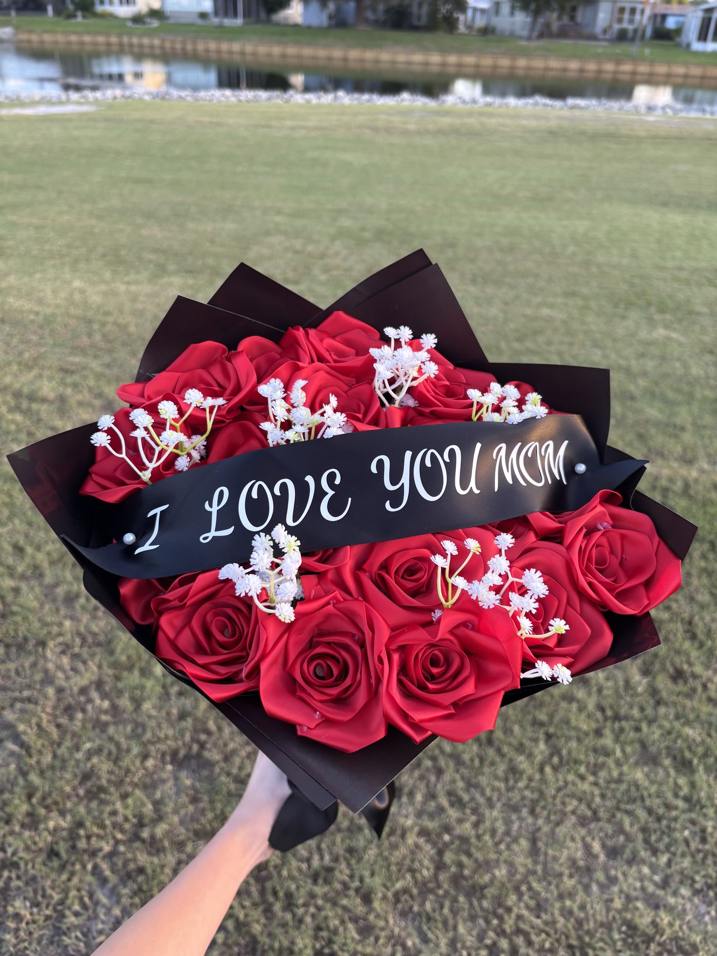 Red ribbon rose bouquet with an I Love You Mom message ribbon