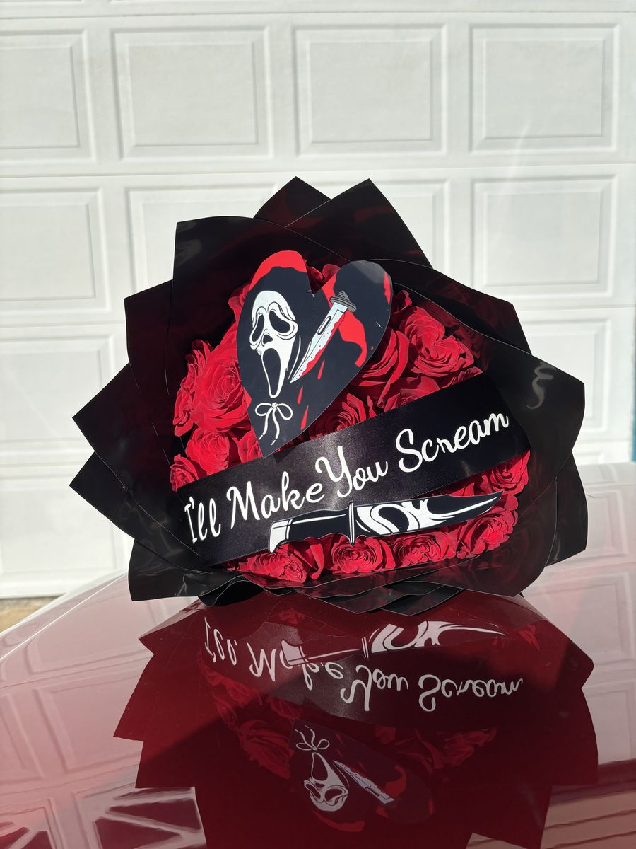 Red and black ribbon rose bouquet with a Scream topper
